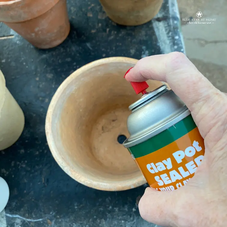 spraying clay pot sealer